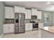 Modern kitchen features granite countertops, stainless steel appliances, and white cabinetry at 7028 N Plum Tree, Punta Gorda, FL 33955
