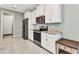 Updated kitchen features white cabinetry, granite countertops, and stainless steel appliances at 7028 N Plum Tree, Punta Gorda, FL 33955