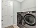 Well-organized laundry room includes front-load washer and dryer with overhead shelving at 7028 N Plum Tree, Punta Gorda, FL 33955