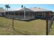 A fenced backyard with large screened in lanai, provides a secure outdoor living space at 7500 Ligustrum, Punta Gorda, FL 33955