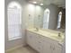 Bathroom featuring dual sinks, vanity with plenty of storage, and a large mirror at 7500 Ligustrum, Punta Gorda, FL 33955