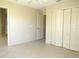 Bedroom featuring tile floors, ceiling fan, window, and closet at 7500 Ligustrum, Punta Gorda, FL 33955