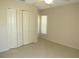 Bedroom featuring tile floors, ceiling fan, window, and closet at 7500 Ligustrum, Punta Gorda, FL 33955