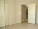 Bedroom featuring tile floors, closet and view into kitchen area at 7500 Ligustrum, Punta Gorda, FL 33955