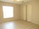Bedroom featuring tile floors, ceiling fan, window, and closet at 7500 Ligustrum, Punta Gorda, FL 33955