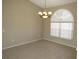 Cozy dining area with tile flooring, chandelier, and window with blinds for a comfortable dining experience at 7500 Ligustrum, Punta Gorda, FL 33955
