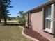 Exterior side view of home features well-maintained landscaping and manicured lawn at 7500 Ligustrum, Punta Gorda, FL 33955