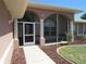 Close-up of the charming screened front porch with arched entryway and tiled walkway, inviting guests inside at 7500 Ligustrum, Punta Gorda, FL 33955