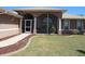 Welcoming screened front porch with stone walkway and arched entryway, perfect for enjoying the outdoors at 7500 Ligustrum, Punta Gorda, FL 33955