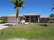 Charming single-Gathering home with a well-manicured lawn, mature palm tree, and attached two-car garage at 7500 Ligustrum, Punta Gorda, FL 33955