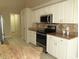 Well-equipped kitchen featuring white cabinets, granite counters, and stainless steel appliances for culinary enthusiasts at 7500 Ligustrum, Punta Gorda, FL 33955
