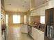 Modern kitchen with granite countertops, stainless steel appliances, and sleek white cabinetry for a stylish cooking space at 7500 Ligustrum, Punta Gorda, FL 33955