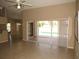 Open-concept living room with tile floors, sliding glass doors to pool area, and seamless indoor-outdoor living at 7500 Ligustrum, Punta Gorda, FL 33955