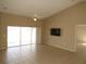 Comfortable living room with tile flooring, sliding glass doors, ceiling fan, and neutral wall colors at 7500 Ligustrum, Punta Gorda, FL 33955
