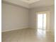 Neutral-toned living room leading out to the pool area; tile floors, bright, and airy at 7500 Ligustrum, Punta Gorda, FL 33955