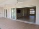 Covered patio with tile floors, ceiling fans, and sliding glass doors leading to home interior at 7500 Ligustrum, Punta Gorda, FL 33955