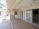 Covered patio with tile floors, ceiling fans, and sliding glass doors leading to home interior at 7500 Ligustrum, Punta Gorda, FL 33955
