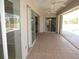 Covered patio with tile floors and sliding glass doors leading to pool and home interior at 7500 Ligustrum, Punta Gorda, FL 33955
