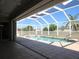 Screened-in pool area featuring tile floors, pool, and clear blue sky at 7500 Ligustrum, Punta Gorda, FL 33955
