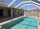 A screened-in pool with turquoise water, tile surround, and access to the home's interior at 7500 Ligustrum, Punta Gorda, FL 33955