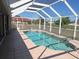 Sparkling screened-in pool with tile surround offers a relaxing outdoor retreat at 7500 Ligustrum, Punta Gorda, FL 33955
