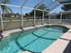 Inviting screened-in pool with clear blue water and tiled deck, perfect for leisure at 7500 Ligustrum, Punta Gorda, FL 33955