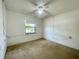 Bedroom with a ceiling fan, window, and electrical boxes on the wall at 1081 E Corktree Cir, Port Charlotte, FL 33952