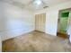 Bedroom with a ceiling fan, closet, and an en suite bathroom at 1081 E Corktree Cir, Port Charlotte, FL 33952