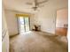 Bedroom with sliding glass doors to the backyard with neutral paint and ceiling fan at 1081 E Corktree Cir, Port Charlotte, FL 33952