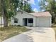 Charming single-story home with a well-maintained lawn and attached single car garage at 1081 E Corktree Cir, Port Charlotte, FL 33952