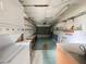 Functional garage space equipped with shelving and washer/dryer hookups at 1081 E Corktree Cir, Port Charlotte, FL 33952