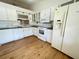White kitchen features ample cabinet space and includes a refrigerator, microwave, and stove at 1081 E Corktree Cir, Port Charlotte, FL 33952