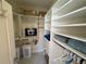 Spacious walk-in closet with built in shelving and ample storage space for clothes and accessories at 10900 Lerwick Cir, Englewood, FL 34223