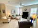 Bright living room with tile flooring, ceiling fan, and comfortable seating at 10900 Lerwick Cir, Englewood, FL 34223