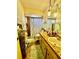 A cozy bathroom with a vanity, mirror, shower with patterned curtain, and tile flooring at 1148 Barbour Ave, Port Charlotte, FL 33948
