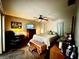 This is a warm bedroom featuring neutral walls and a comfortable bed with end tables and a chair at 1148 Barbour Ave, Port Charlotte, FL 33948