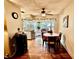 Dining room with wood floors and a round table with chairs near sliding glass doors to the patio at 1148 Barbour Ave, Port Charlotte, FL 33948
