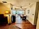 A dining room featuring wood floors and a round table with an overhead fan and sliding glass doors to patio at 1148 Barbour Ave, Port Charlotte, FL 33948