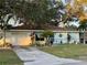 Charming single-story home with a well-maintained lawn, mature trees, and inviting curb appeal at 1148 Barbour Ave, Port Charlotte, FL 33948
