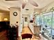 An eat-in kitchen next to living room that features white cabinets and wood laminate flooring with glass doors to a patio at 1148 Barbour Ave, Port Charlotte, FL 33948
