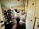 Functional laundry room with a washer, dryer, storage shelves, and cabinets, providing convenient laundry solutions at 1148 Barbour Ave, Port Charlotte, FL 33948