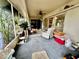 Relaxing sunroom with sliding glass doors, neutral color carpet, and ceiling fan providing serene comfort and bright lighting at 1148 Barbour Ave, Port Charlotte, FL 33948