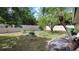 Backyard with patio seating, lush landscaping, and white fenced perimeter at 131 Spring Lake Nw Blvd, Port Charlotte, FL 33952