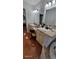 Bathroom featuring a double sink vanity with granite countertop, and wood floors at 131 Spring Lake Nw Blvd, Port Charlotte, FL 33952