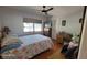 Cozy bedroom with a floral comforter, wood floors, a window, and a decorative desk at 131 Spring Lake Nw Blvd, Port Charlotte, FL 33952