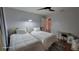 Neutral bedroom featuring two twin beds, ceiling fan, and view into the hall at 131 Spring Lake Nw Blvd, Port Charlotte, FL 33952