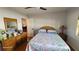 Bright bedroom with a floral comforter, hardwood floors, and ample natural light at 131 Spring Lake Nw Blvd, Port Charlotte, FL 33952