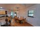 Cozy dining area adjacent to the kitchen features wood flooring, a stylish pendant light, and plantation shutters at 131 Spring Lake Nw Blvd, Port Charlotte, FL 33952