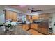 Modern kitchen featuring stainless steel appliances, wooden cabinets, granite countertops, and an open design at 131 Spring Lake Nw Blvd, Port Charlotte, FL 33952