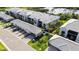 Aerial view of condos with gray tile roofs, attached garages, and green landscaping at 14281 Heritage Landing Blvd # 1418, Punta Gorda, FL 33955